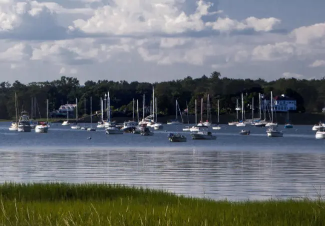From Tod’s Point in Old Greenwich, Connecticut, showing boats, docks, the tree-lined shore and beautiful waterfront homes.